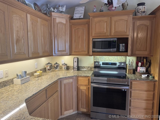 kitchen featuring light stone countertops and stainless steel appliances