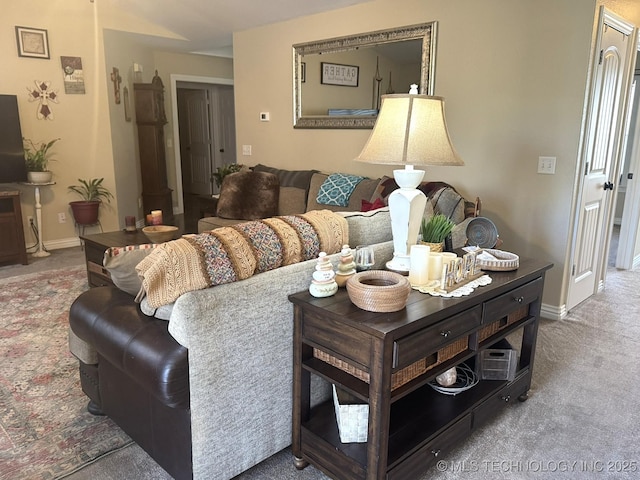 carpeted living room with baseboards