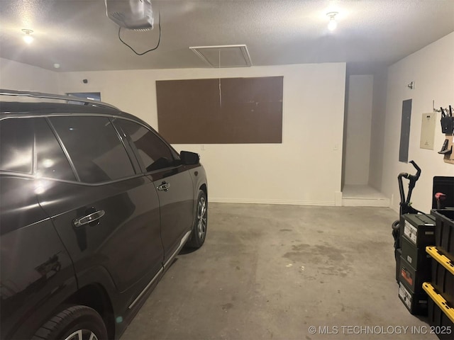 garage with electric panel and a garage door opener