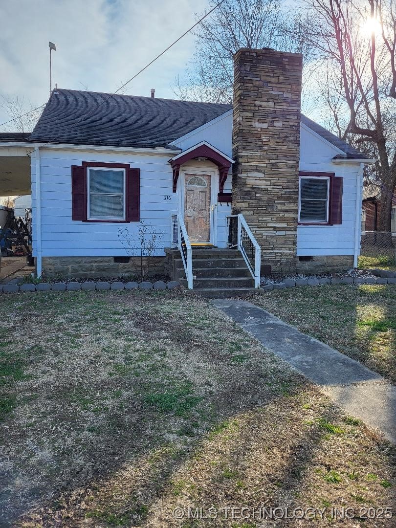 bungalow with fence, a chimney, roof with shingles, and crawl space