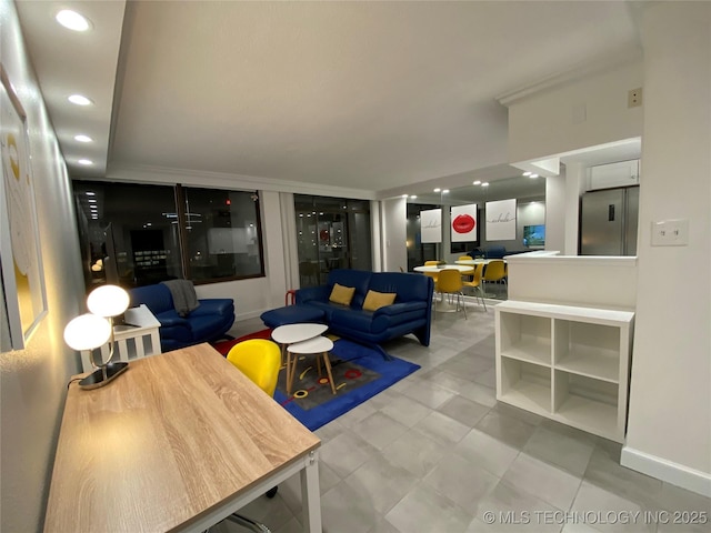 living area featuring recessed lighting and baseboards