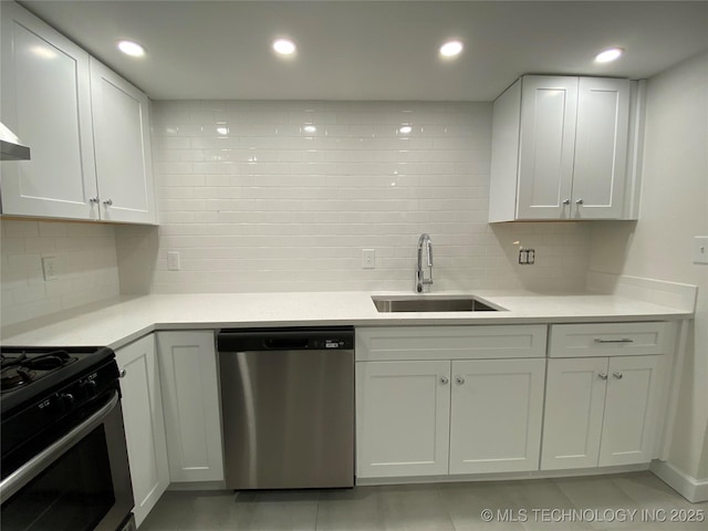 kitchen with a sink, white cabinetry, recessed lighting, stainless steel appliances, and light countertops