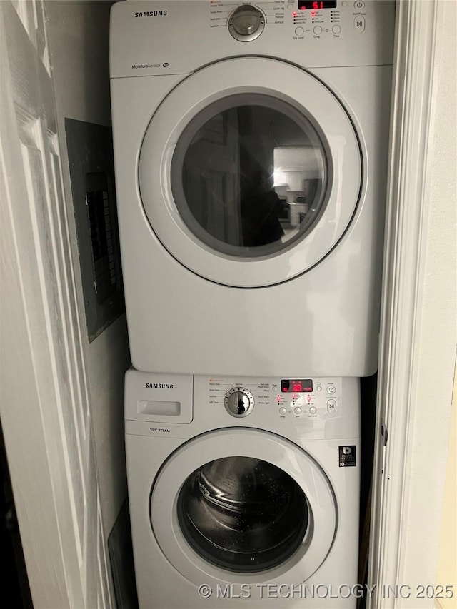 washroom featuring laundry area and stacked washer / dryer