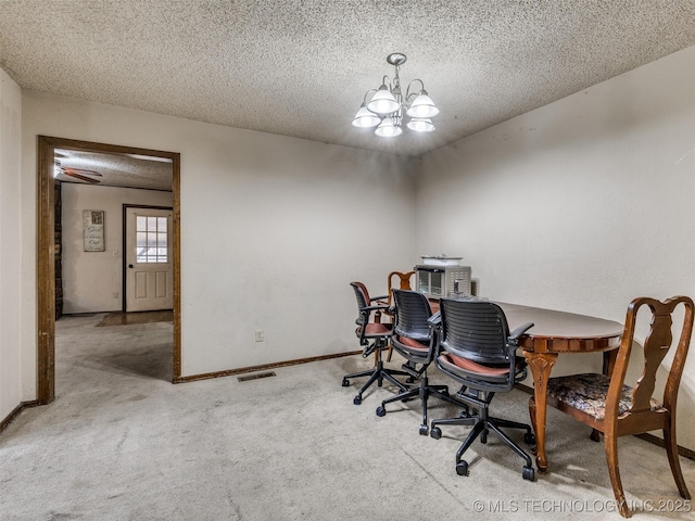 carpeted home office with a notable chandelier, baseboards, and a textured ceiling