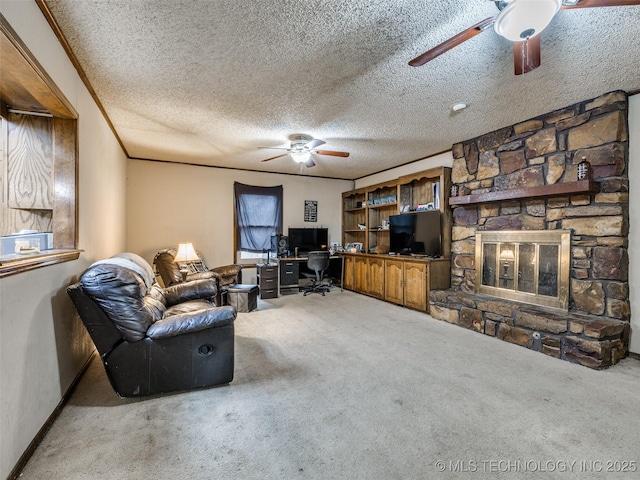 living room with ceiling fan, a fireplace, carpet floors, and ornamental molding