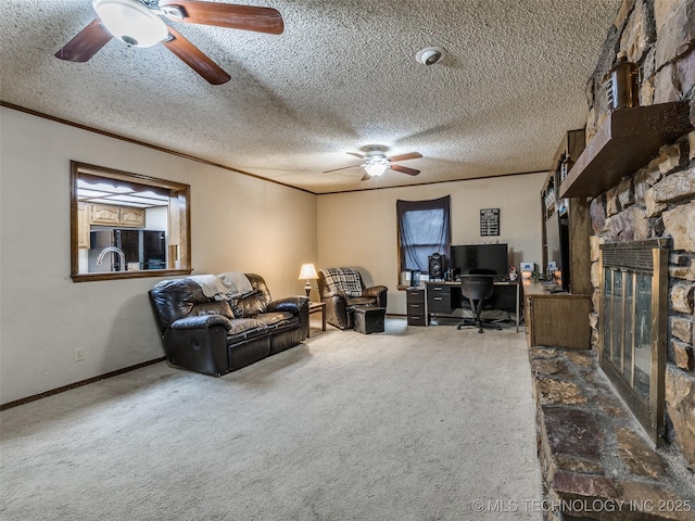 carpeted living room with a fireplace, a textured ceiling, crown molding, and ceiling fan