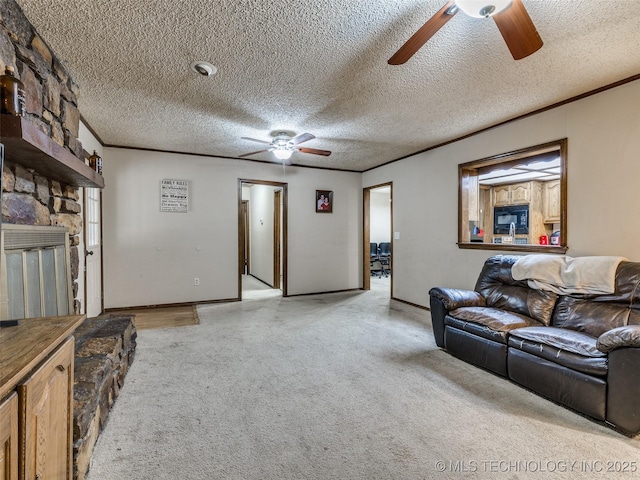 living area with a stone fireplace, crown molding, a ceiling fan, and a textured ceiling