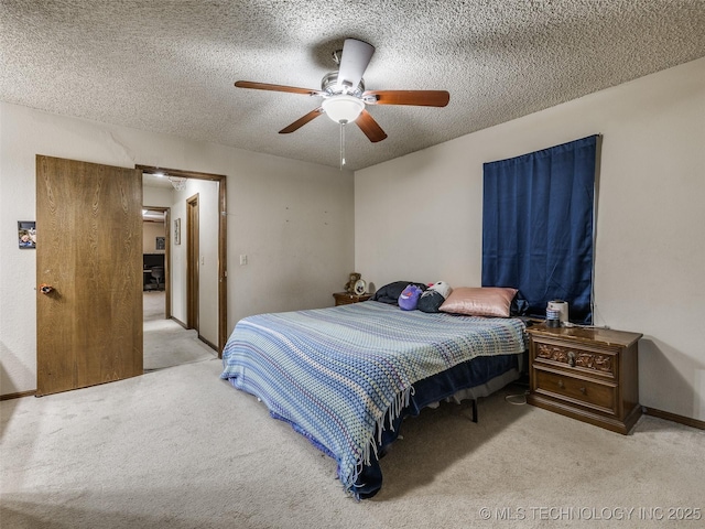 bedroom with ceiling fan, carpet, baseboards, and a textured ceiling