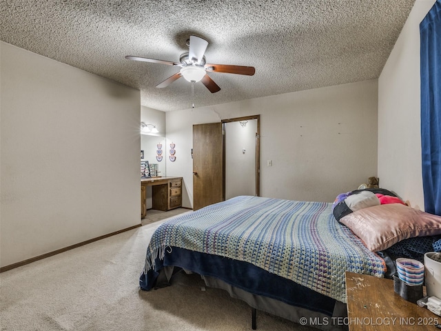 carpeted bedroom featuring a ceiling fan, baseboards, and a textured ceiling