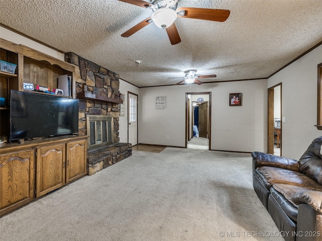 living area featuring a ceiling fan, ornamental molding, a stone fireplace, a textured ceiling, and light carpet