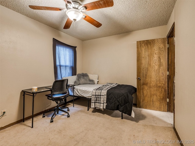 bedroom featuring a ceiling fan, carpet, baseboards, and a textured ceiling