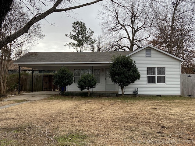 ranch-style house featuring a carport, driveway, a front yard, and fence