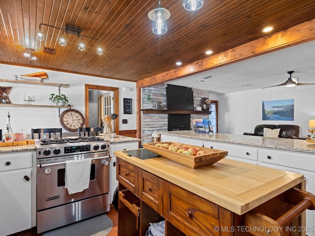 kitchen featuring stainless steel gas stove, wood counters, open floor plan, white cabinetry, and wooden ceiling