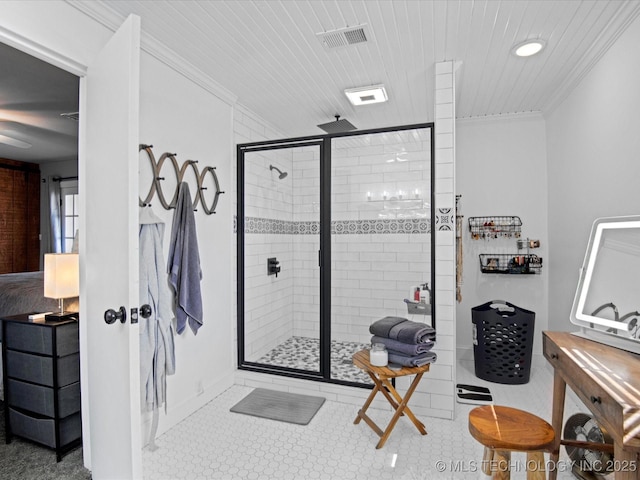 bathroom with visible vents, a stall shower, and ornamental molding