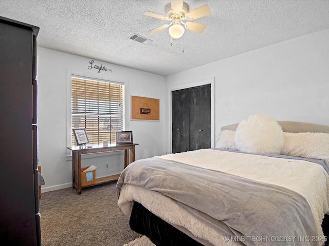 bedroom featuring visible vents, a textured ceiling, carpet floors, baseboards, and ceiling fan