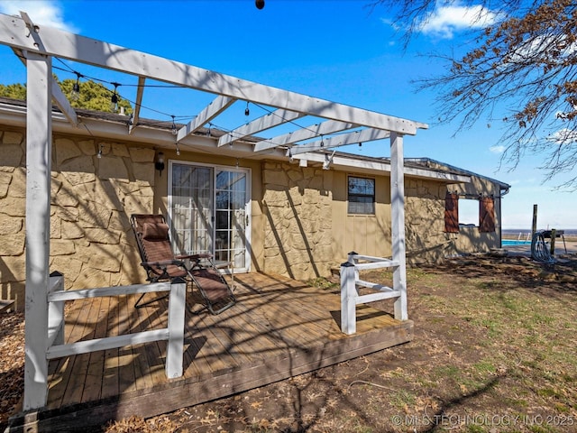 exterior space with stone siding and a wooden deck