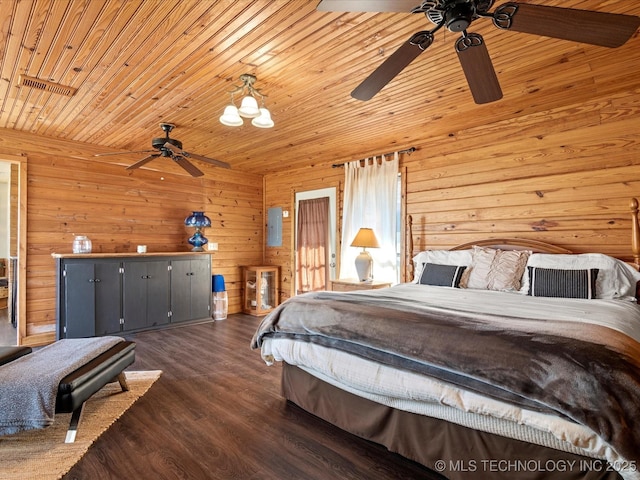 bedroom with a ceiling fan, wooden ceiling, wooden walls, and wood finished floors