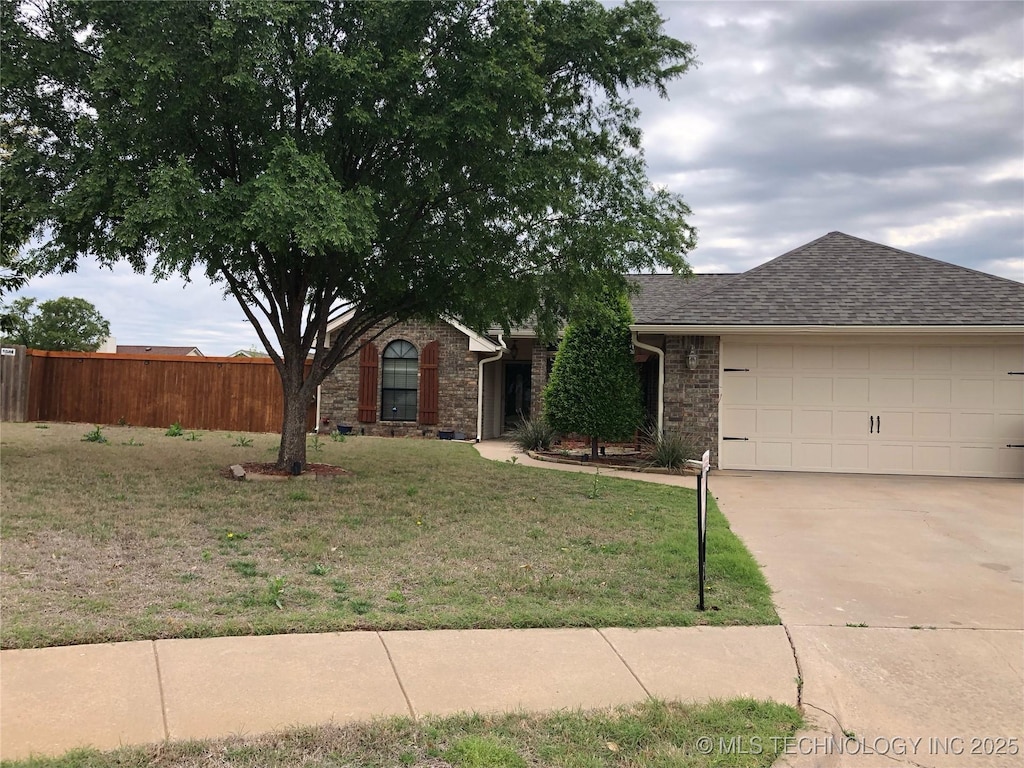 ranch-style house with fence, driveway, a shingled roof, a front lawn, and a garage