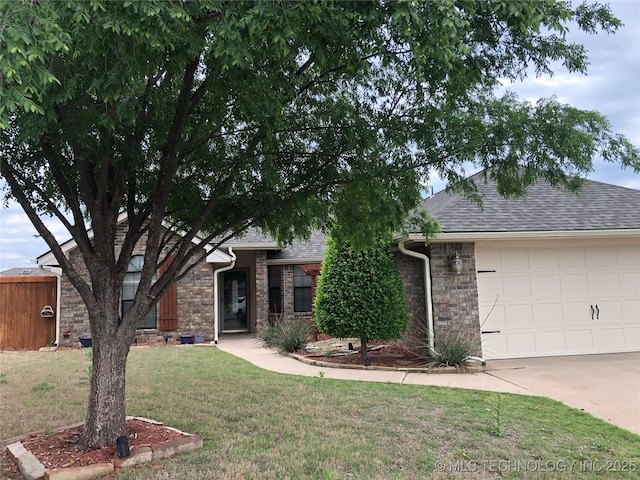 view of front of property with brick siding, a shingled roof, a front lawn, driveway, and an attached garage