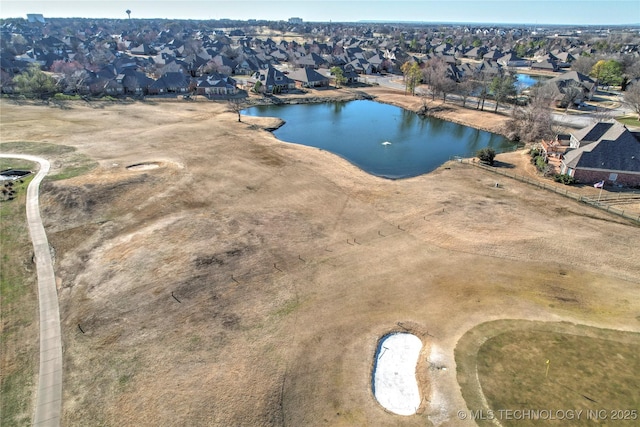 drone / aerial view featuring a residential view and a water view