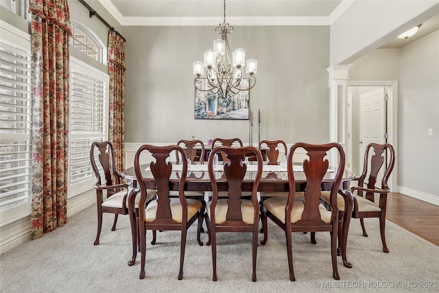 dining space with a chandelier, wood finished floors, baseboards, and ornamental molding