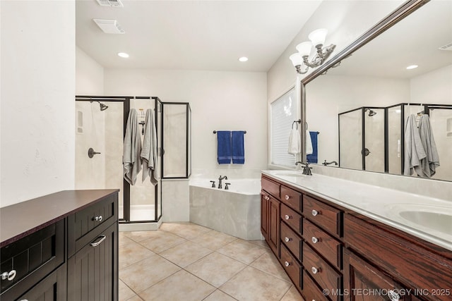 bathroom featuring double vanity, a stall shower, a sink, tile patterned floors, and a bath