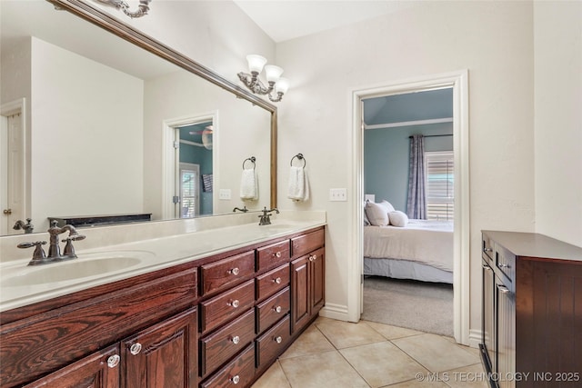 full bath with double vanity, connected bathroom, tile patterned floors, and a sink