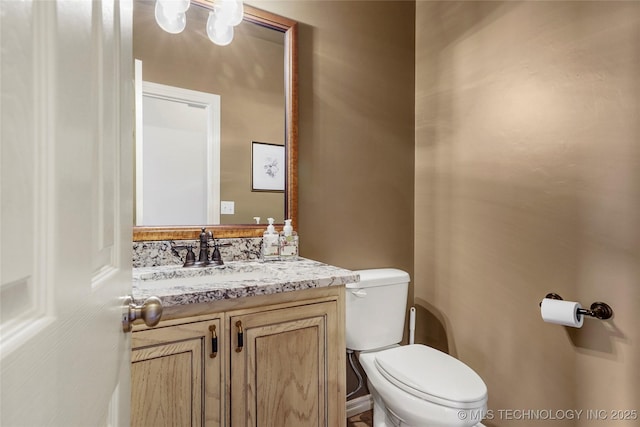 bathroom featuring toilet and vanity