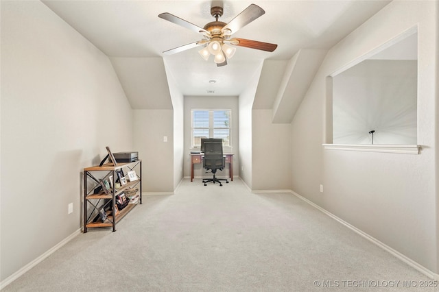 carpeted home office with baseboards and a ceiling fan