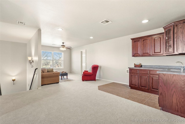 living area featuring a ceiling fan, recessed lighting, light colored carpet, and visible vents