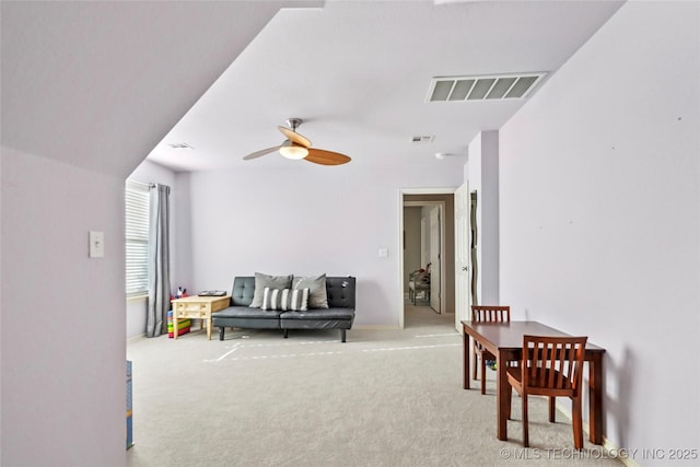 interior space with visible vents, ceiling fan, and carpet flooring