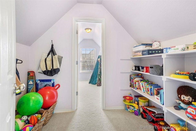 recreation room with vaulted ceiling, carpet, and baseboards