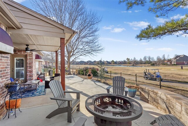 view of patio / terrace with a fire pit and fence