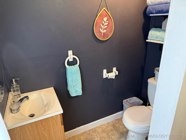 bathroom with tile patterned flooring, toilet, vanity, and baseboards