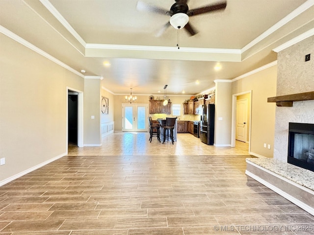 living room with a fireplace, baseboards, and wood finish floors