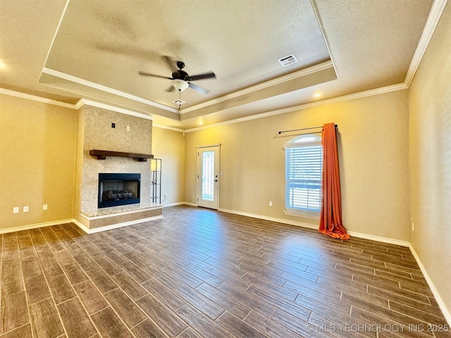 unfurnished living room featuring visible vents, a raised ceiling, and wood tiled floor