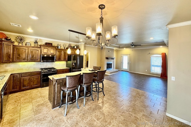 kitchen with tasteful backsplash, visible vents, crown molding, a breakfast bar, and appliances with stainless steel finishes