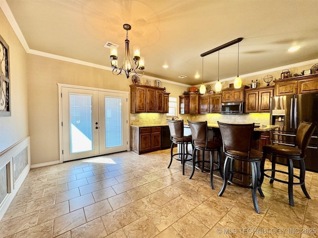 kitchen with stainless steel microwave, light countertops, fridge with ice dispenser, decorative backsplash, and french doors