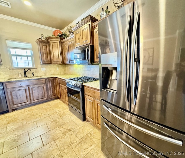 kitchen with visible vents, backsplash, light stone countertops, stainless steel appliances, and a sink