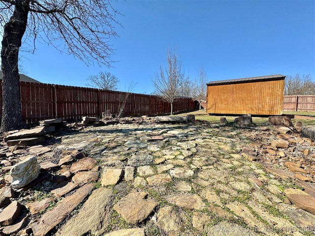 view of yard with an outdoor structure and a fenced backyard