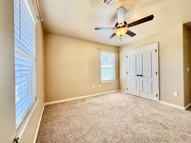 unfurnished bedroom featuring a closet, visible vents, baseboards, and carpet