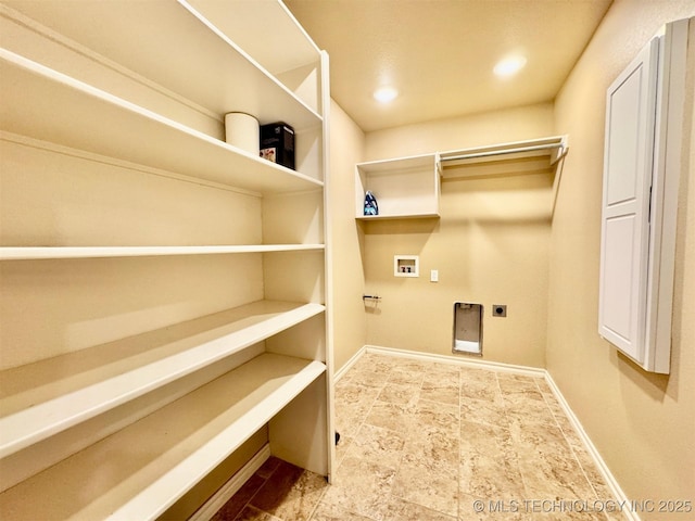 laundry area featuring laundry area, hookup for a washing machine, hookup for an electric dryer, and baseboards