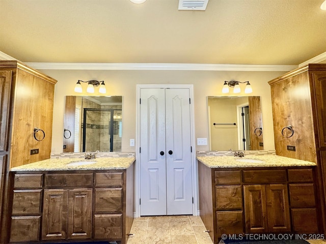 full bathroom with a sink, visible vents, two vanities, and a stall shower