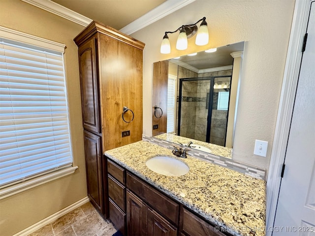 full bath featuring baseboards, vanity, a shower stall, and crown molding