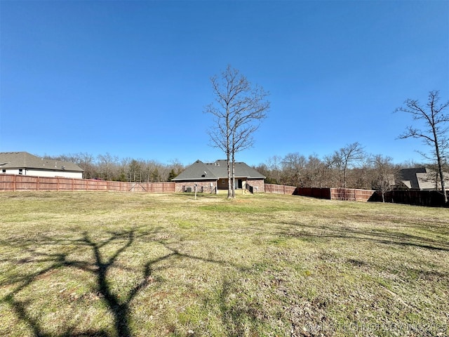 view of yard featuring a rural view and a fenced backyard