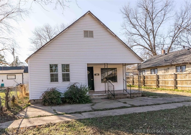 bungalow-style house with a porch and fence