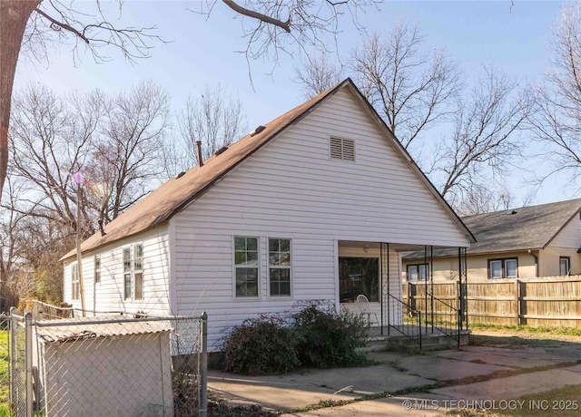 exterior space featuring a porch and fence