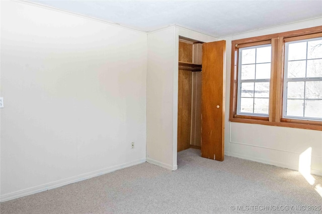 unfurnished bedroom with carpet flooring and baseboards