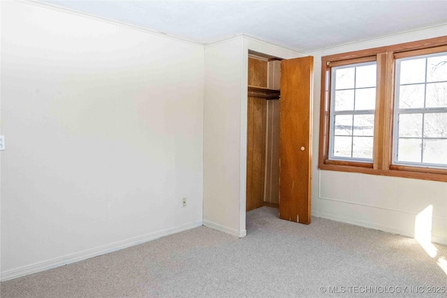 unfurnished bedroom featuring baseboards and carpet flooring