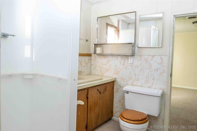 bathroom with vanity, visible vents, wallpapered walls, ornamental molding, and toilet